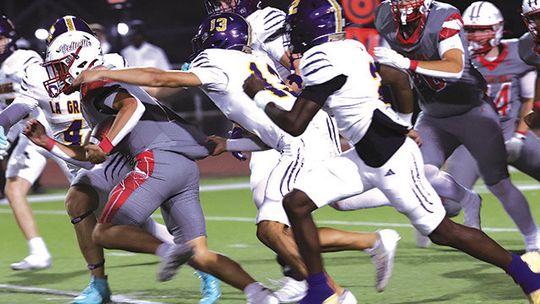 La Grange defenders pursue Bellville halfback Rody Luera