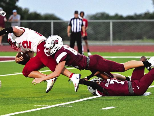 Flatonia Bulldog senior Austin Arnett stretches out to stop a Cardinal from entering the Bulldog end zone in Friday nights season opener against St