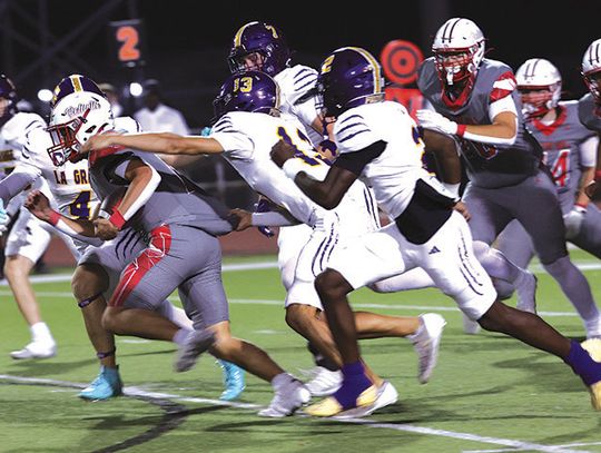 La Grange defenders pursue Bellville halfback Rody Luera