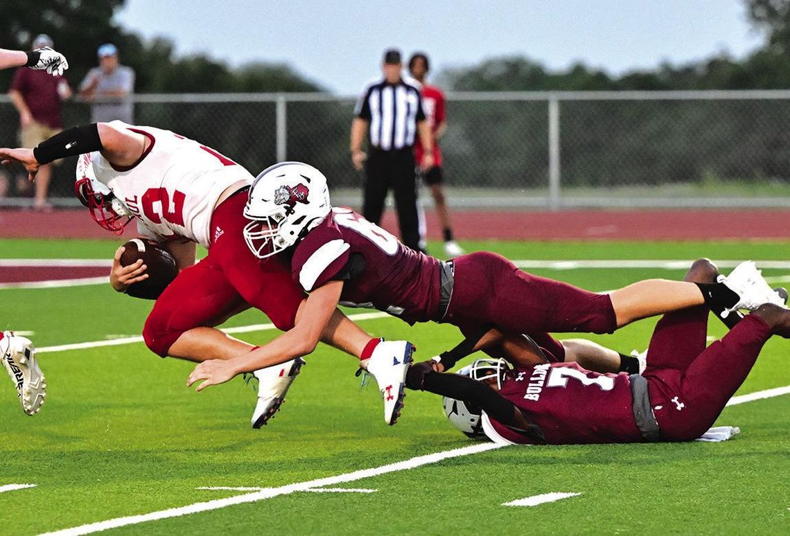 Flatonia Bulldog senior Austin Arnett stretches out to stop a Cardinal from entering the Bulldog end zone in Friday nights season opener against St