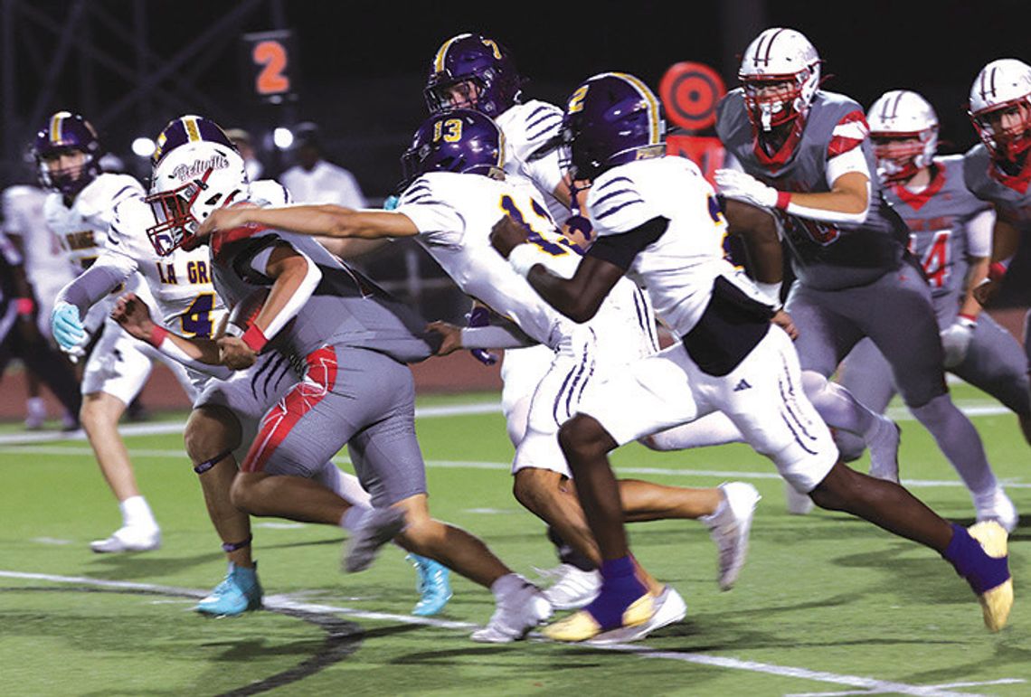La Grange defenders pursue Bellville halfback Rody Luera
